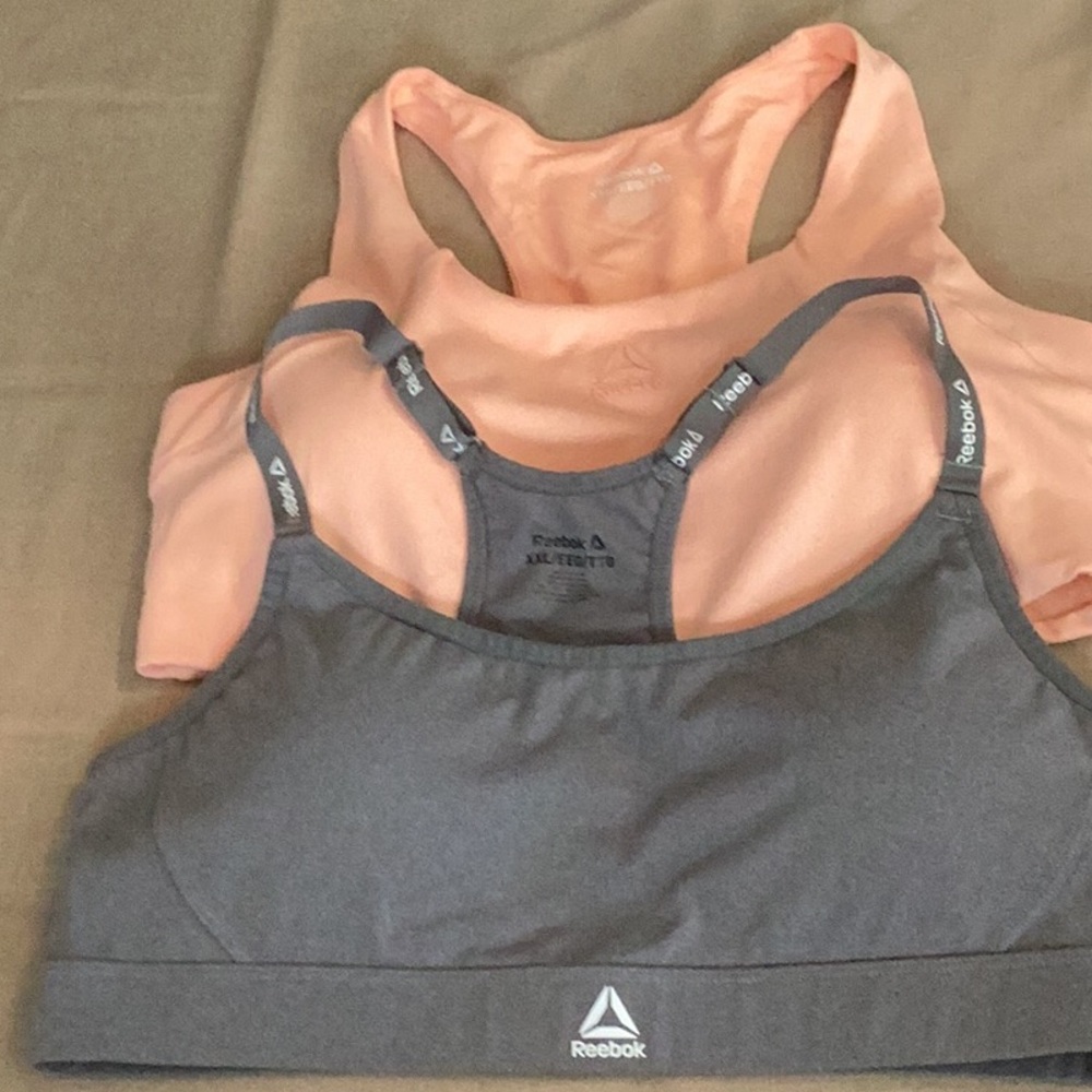 Reebok charcoal, gray, and peach pair of sports bras.